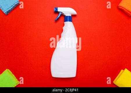 glass cleaner spray. cleaning agent white spray for cleaning glass with rags on a red background Stock Photo