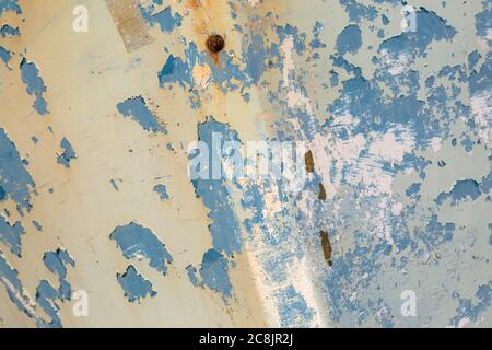 A full frame photograph of textured peeling paint on the side of a boat Stock Photo