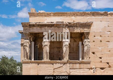 Athens Acropolis, Greece landmark. Caryatid Porch, Erechtheion, Erechtheum Ancient Greek woman statues, blue sky in spring sunny day. Stock Photo