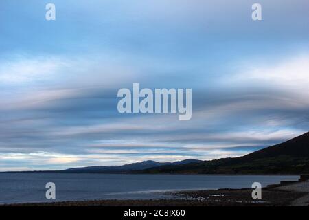 Strange blue and pink cloud formation at sunset over the sea at Trefor, North Wales Stock Photo