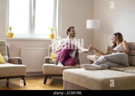 Lovely romantic couple drinking coffee and having a nice conversation at home Stock Photo