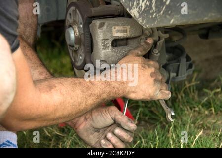 Mechanic replaces the brake pads Stock Photo