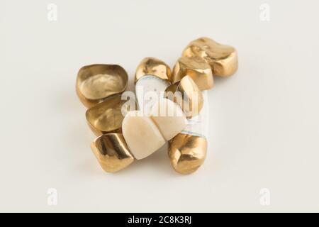 stamped brazed dental bridges covered with gold coated on white background Stock Photo