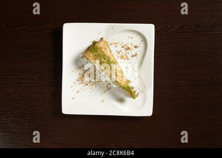 Turkish puff baklava with ice cream honey with pistachios triangular shape, top view. Photos for restaurant and cafe menus Stock Photo