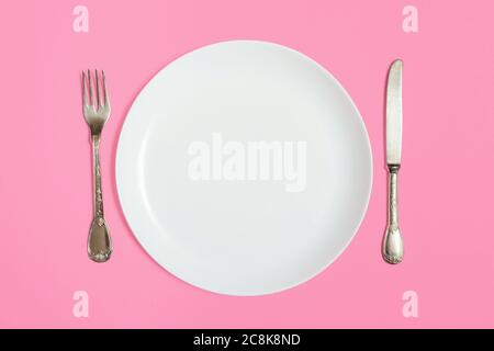White empty plate with fork and knife Stock Photo
