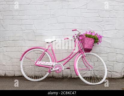 Ballingeary, Cork, Ireland. 25th July, 2020. An old ladies bicycle which has been painted and decorated with Petunias liven up the main street in Ballingeary, Co. Cork, Ireland.  - Credit; David Creedon / Alamy Live News Stock Photo