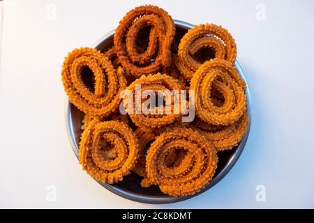 a top shot of traditional chakali snacks isolated on white background Stock Photo