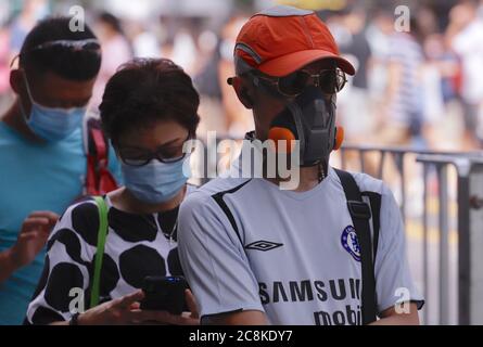 Hong Kong, China. 25th July, 2020. A man wearing an industrial grade protective mask awaiting to board bus coach in the City. Hong Kong is experiencing a daily record-breaking number of new coronavirus infections. Credit: Liau Chung-ren/ZUMA Wire/Alamy Live News Stock Photo