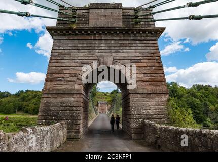 Union Suspension Bridge, 200 year old wrought iron chain bridge, English Scottish border crossing over River Tweed,, UK Stock Photo