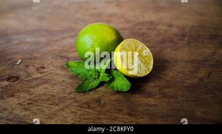 Half cut lemon and peppermint leaves closeup Stock Photo