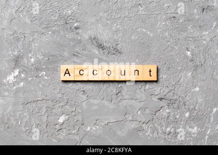 Account word written on wood block. Account text on cement table for your desing, concept. Stock Photo