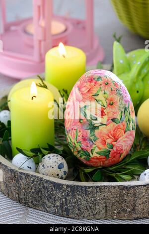 Easter table decoration with eggs, candles and buxus. Festive time Stock Photo