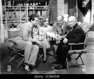 FRED MacMURRAY CAROLE LOMBARD Director MITCHELL LEISEN and Paramount Founder ADOLPH ZUKOR on set candid during filming of SWING HIGH , SWING LOW 1937 Paramount Pictures Stock Photo