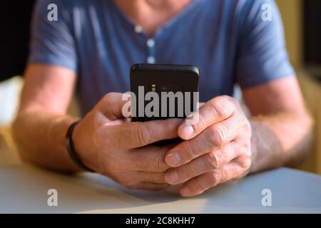 Senior handsome Scandinavian man relaxing inside the coffee shop Stock Photo