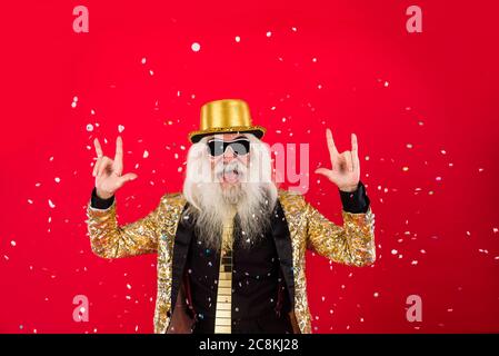 Senior man with eccentric look  - 60 years old man having fun, portrait on colored background, concepts about youthful senior people and lifestyle Stock Photo