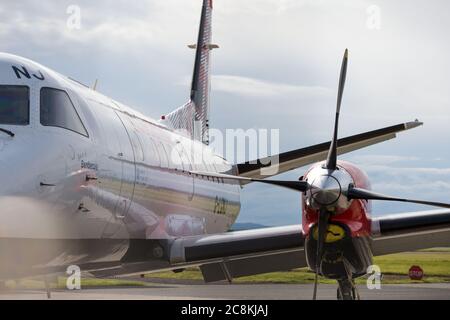 Glasgow, Scotland, UK. 21 July 2020. Pictured: Loganair Saab 340 aircraft sen on the tarmac one evening during the coronavirus (COVID19) crisis. Loganair are slowly starting back part of their flying schedule. Credit: Colin Fisher/Alamy Live News. Stock Photo