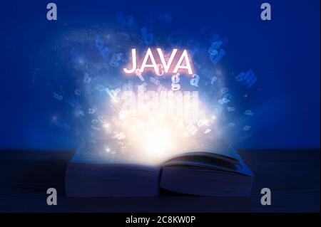 Open book with java inscription. Light coming from open book with word java. Learn programming language. Stock Photo