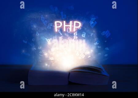 Open book with php inscription. Light coming from open book with word php. Learn programming language. Stock Photo