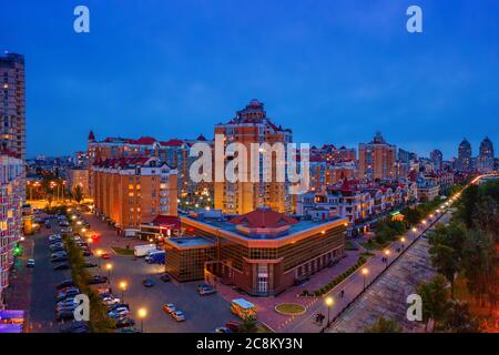 Night aerial view on Obolon area of Kyiv city with illumination. Flying drone camera shot. Stock Photo