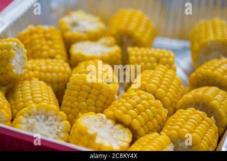 Shiny yellow sweet corn cobs in a metal plate Stock Photo