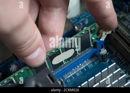 Desktop DDR RAM, against the background of a computer motherboard, closeup shot Stock Photo