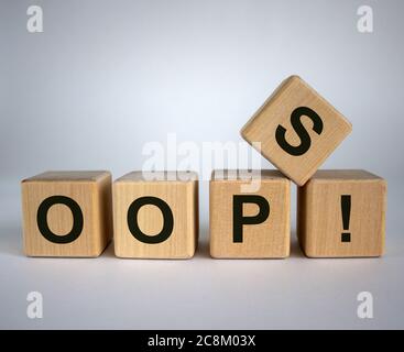 Oops sign on wooden cubes. Beautiful white background, copy space. Concept. Stock Photo