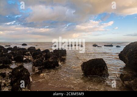 Looking out to sea over a rocky beach, near Eastbourne in Sussex Stock Photo