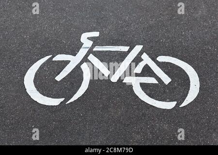 White bicycle sign on a road closeup Stock Photo