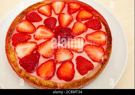 Delicious homemade strawberry tart. Isolated on wooden background. Top view. Close-up. Horizontal shot. Stock Photo