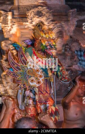 Dramatic photo of colorfully dressed Kecak dancers dressed in traditional, brightly colored costumes perform Balinese Hindu Ramayana Temple dance. Stock Photo