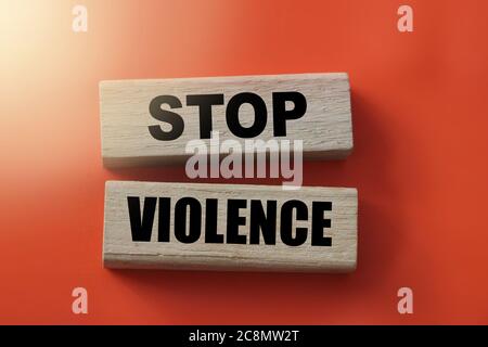 Stop violence words on Wooden building blocks on red. Stop racism concept. Stock Photo