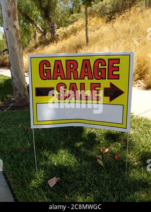 Garage sale sign posted on the roadside Stock Photo