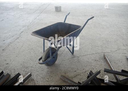 Industrial obsolete wheelbarrow is used for transportation burden