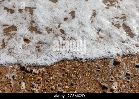 Waves lapping the pebbles on Brighton beach, England, United Kingdom Stock Photo