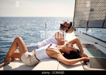Young couple enjoy on a yacht on sunny day Stock Photo