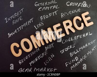 Commerce word presented on chalk board with wooden alphabets collection on black educational background. Stock Photo