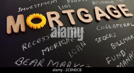 Mortgage text displayed on black board with 3d word on dark education surface texture. Stock Photo
