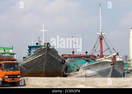 Jakarta / indonesia - July 20, 2020 - Pinisi ships leaning on the port, are waiting for the contents of the cargo Stock Photo