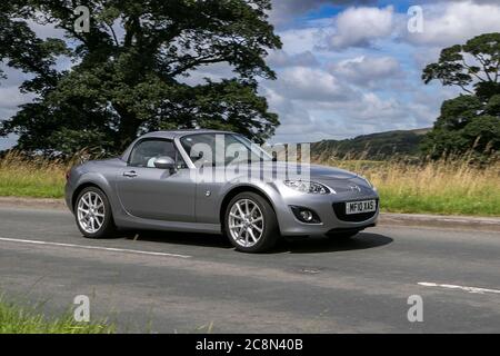 2010 silver Mazda Mx-5 I Roadster Auto traffic moving vehicles, car driving vehicle on UK roads, Stock Photo