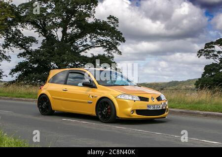 2007 yellow Renault Megane R-Sport 230 F1 R26; traffic moving vehicles, car driving vehicle on UK roads, Stock Photo