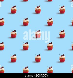 Tasty cupcake seamless pattern on blue background. Cupcakes decorated with cherry and chocolate Stock Photo