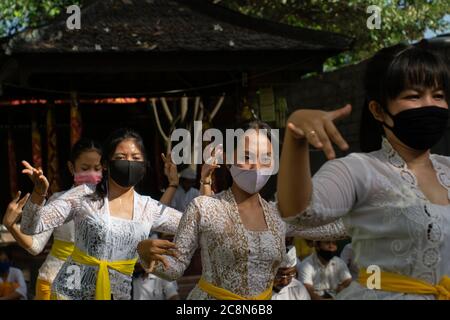 BALI/INDONESIA-JULY 3 2020: The New Normal life in Bali. The prayer program at the temple accompanied by a traditional dance where the dancers wore he Stock Photo