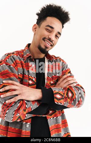 Photo of a handsome african happy cheery young man posing isolated over ...