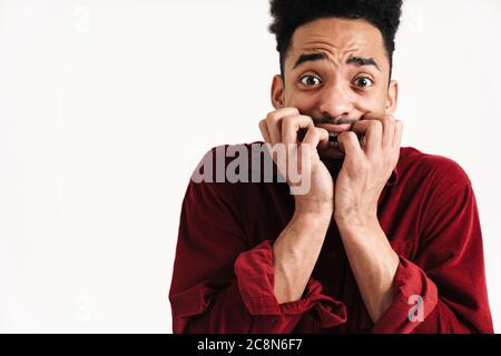 Photo of scared african young man posing isolated over white wall background Stock Photo