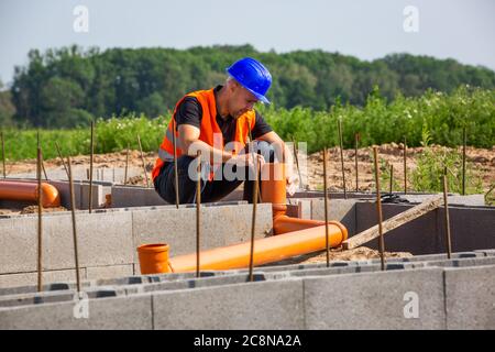 Construction manager checking the new bungalow foundation of the house, building concept Stock Photo