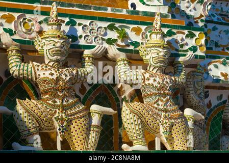 Sculptures of Rakshasa demons supporting the main prang of the Temple of the Morning Dawn (Wat Arun). Bangkok, Thailand Stock Photo