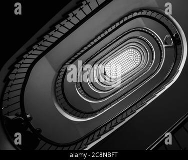 Black and white photo of old spiral staircase, spiral stairway inside old house in Budapest, Hungary Stock Photo