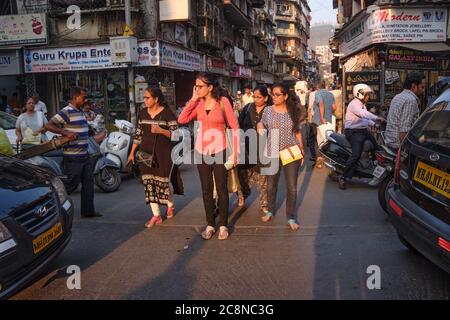 A group of women try to cross busy and congested Kalbadevi Road in Bhuleshwar trading area, Mumbai, India Stock Photo