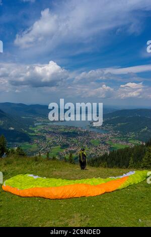 Parachute glider looking at hill over the Tegernsee in Germany Stock Photo