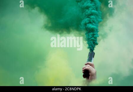 protester hand in the colored smokey Stock Photo